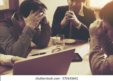 Team Of Unhappy Businesspeople Sitting In Business Meeting./strain Meeting