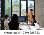 Team of ux designers collaborating, developing user experience and mobile application interface wireframes in a modern office space