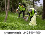 Team volunteer worker group enjoy charitable social work outdoor in cleaning up garbage and waste separation project at the park or natural forest for community service and recycle