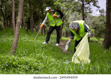 Team volunteer worker group enjoy charitable social work outdoor in cleaning up garbage and waste separation project at the park or natural forest for community service and recycle - Powered by Shutterstock