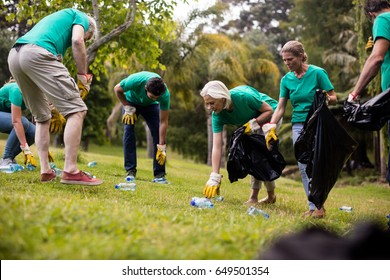 Team Of Volunteers Picking Up Litter In Park