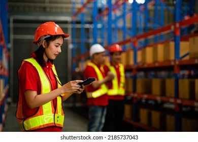 A Team Of Warehouse Workers Prepare Cardboard Boxes For Shipping In A Large Warehouse Distribution Center. .International Export Concept