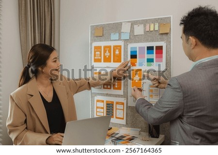 A team of web developers discusses how to best organize a website layout. They share ideas on how to best optimize a digital product, ux ui team is working together in the office