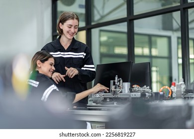 Team woman of engineers practicing maintenance Taking care and practicing maintenance of old machines in the factory so that they can be used continuously. - Shutterstock ID 2256819227