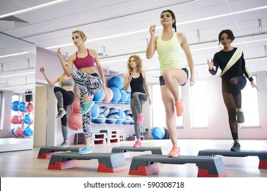 Team Of Women Having Step Aerobics Class 