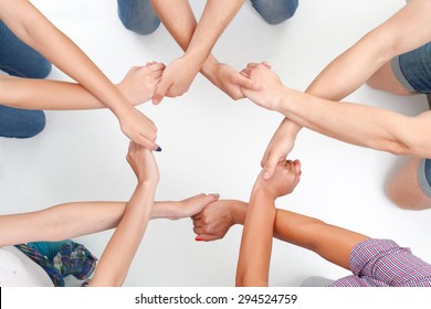 Team Work. Group Of Young Friendly People Making Ring Of Hands On White Isolated Background.