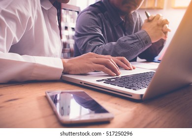 Team Work Process. Business Crew Working With New Start Up Project. Notebook On Wood Table, Typing Keyboard. Analyze Plans. Color Tone.