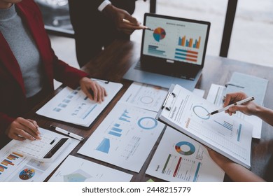 Team work process Business team use calculator to calculate figures, business statistics, profit, cost analysis, growth rate graph document. Data charts on the desk. - Powered by Shutterstock