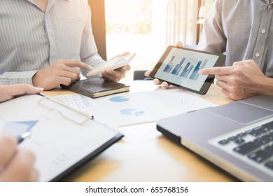 Team work process. young business managers crew working with new startup project. labtop on wood table, typing keyboard, texting message, analyze graph plans. - Shutterstock ID 655768156
