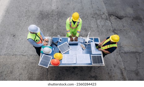 Team worker checking inventory about solar cell and turbine at Container cargo harbor for import, and export industries. Logistics concept.