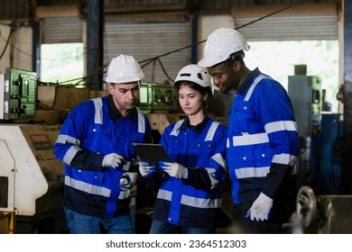 Team worker wearing uniform safety brainstorming holding using tablet plan work management perform working machine at factory. engineer industry work metal product mechanical manufacturing. - Shutterstock ID 2364512303