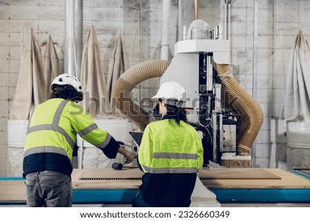 team worker work control operate wood milling machine in wood furniture workshop. technician staff teamwork working with modern industry machine