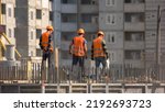 Team of workers doing electrical installation. Fast motion of buidling construction workers installing a wire.