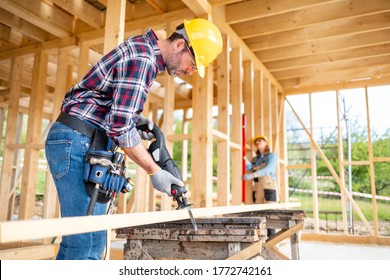 Team Of Workers Doing Woodwork At Construction Site Of Wood Frame House