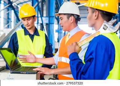 Team Of Workers And Engineer  In Factory At Production Training With Laptop