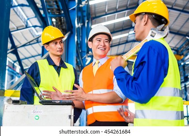 Team Of Workers And Engineer  In Factory At Production Training With Laptop