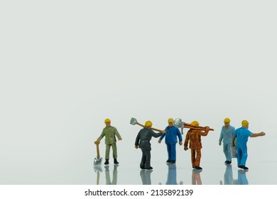 A team of workers with shovels isolated on white background