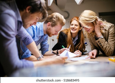 Team working on project together and sharing ideas in workshop - Shutterstock ID 518683495