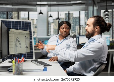 Team working together in office to optimize sustainable solar panel fabrication with advanced assembly lines. Coworkers innovate clean solar energy equipment manufacturing processes