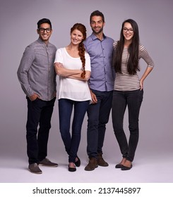 The Team You Can Depend On. Studio Shot Of A Group Of Diverse Young People Against A Gray Background.