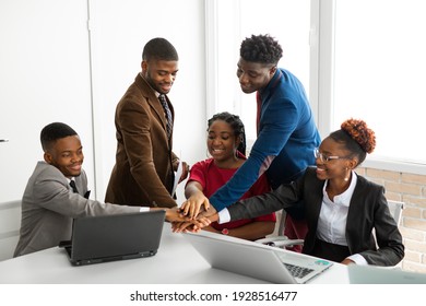 team of young african people in the office at the table with laptops 