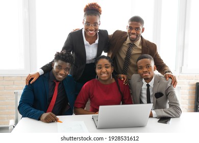 Team Of Young African People In The Office At The Table With Laptops 