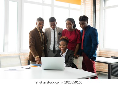 Team Of Young African People In The Office At The Table With A Laptop 