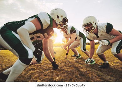 Team Of Young American Football Players Lining Up In Formation During An Afternoon Practice Session