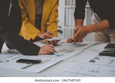 A team of young Asian entrepreneurs had a small team meeting. For upcoming projects in online marketing and management, sales, calculations, business work projects for startups. Teamwork concept. - Powered by Shutterstock