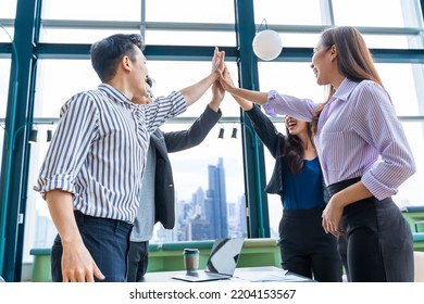 Team of young Asian entrepreneurs and startup have business meeting and encouraging each other for good energy to accomplish successful marketing plan - Shutterstock ID 2204153567