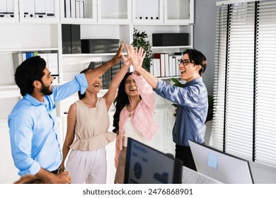 Team of young Asian, Indian and Thai entrepreneurs and startup have business meeting, encouraging and high five each other for good energy to accomplish successful marketing plan. Diversity of team. - Powered by Shutterstock