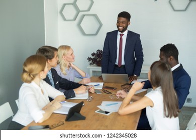team of young business people discussing things at work in the office - Shutterstock ID 1242345028