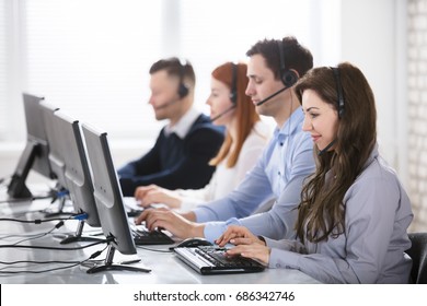 Team Of Young Customer Support Phone Operators Working In Office