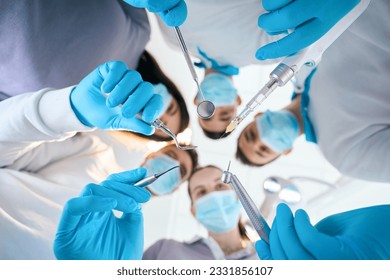 Team of young dentists with special tools in their hands - Powered by Shutterstock