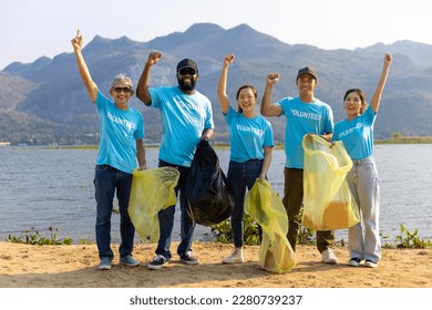 Team of young and diversity volunteer worker group enjoy charitable social work outdoor in cleaning up garbage and waste separation project at the river beach - Powered by Shutterstock