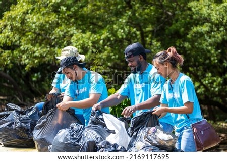 Team of young and diversity volunteer worker group enjoy charitable social work outdoor in cleaning up garbage and waste separation project at the mangrove forest