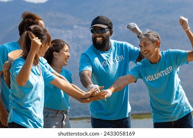 Team of young and diversity volunteer workers group enjoy charitable social work outdoor together to saving environment project wearing blue t-shirt while joining hand in power assemble unity - Powered by Shutterstock