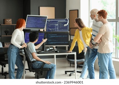 Team of young programmers working in office