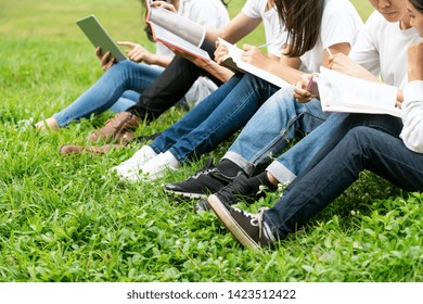 Team Of Young Students Studying In A Group Project In The Park Of University Or School. Happy Learning, Community Teamwork And Youth Friendship Concept.