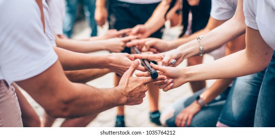 teambuilding activity with stick and hands colleagues - Shutterstock ID 1035764212