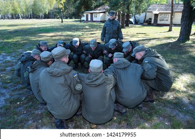 Team-building Exercise: Soldiers Sitting On A Ground And Holding Each Other’s Hands. October 18, 2018. Novo-Petrivtsi Military Base, Ukraine 