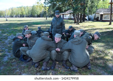 Team-building Exercise: Soldiers Sitting On A Ground And Holding Each Other’s Hands. October 18, 2018. Novo-Petrivtsi Military Base, Ukraine 