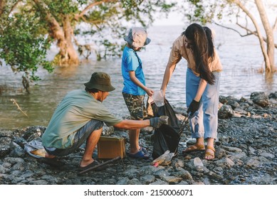 Teamwork Of Asian Family Environment Conservation Volunteer Help To Picking Plastic And Foam Garbage On Park Area.Volunteering World Environment Day.