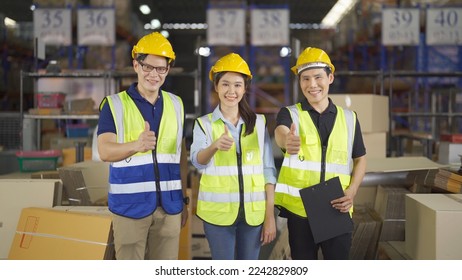 Teamwork of Asian workers working in large warehouse store industry.Rack of stock storage. Interior of cargo in ecommerce and logistic concept. Depot. People lifestyle. Shipment service for container