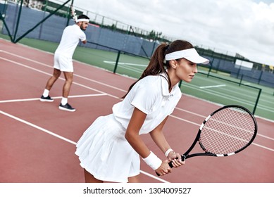 Teamwork. Beautiful woman and handsome man are playing tennis