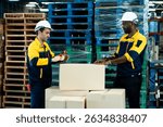 Teamwork between warehouse workers sealing cardboard boxes using tape dispenser while preparing for shipment in logistics warehouse, including african adult male and caucasian adult male staff