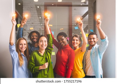Teamwork and brainstorming concept with businessmen that share an idea with a lamp. Concept of startup. - Shutterstock ID 1755217196