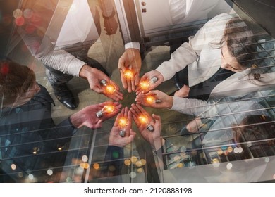 Teamwork and brainstorming concept with businessmen that share an idea with a lamp - Shutterstock ID 2120888198