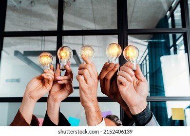 Teamwork and brainstorming concept with businessmen that share an idea with a lamp - Shutterstock ID 2152406139