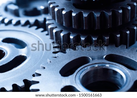 Teamwork business concept - perspective view of engine gear wheel, for industrial background with blur effect